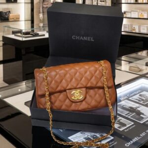This is a brown quilted lambskin Chanel Classic 11.12 handbag featuring a gold-tone turnlock clasp.